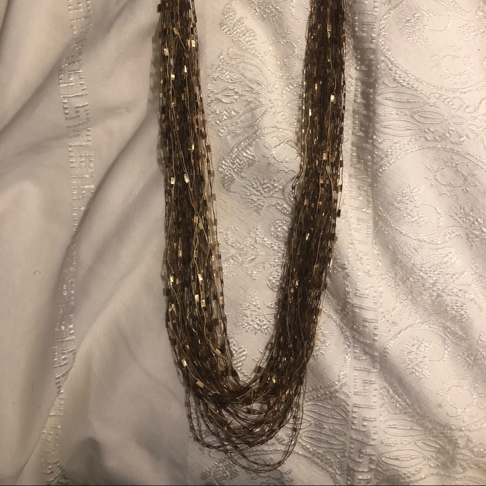 Gold toned 24” long material necklace